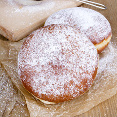 donuts with powdered sugar on a wooden table