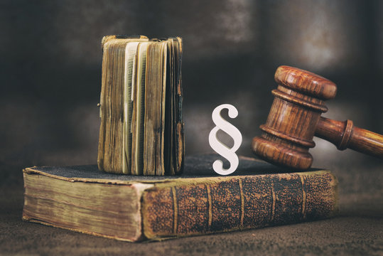 Law gavel on old brown leather book 