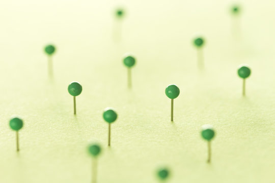 Green pins on green background