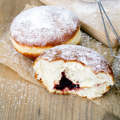 bitten donut on a wooden table