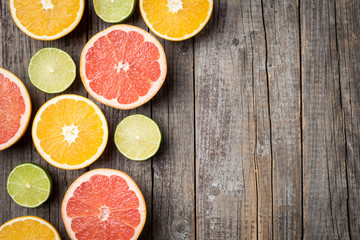 Colorful fruits background with orange, grapefruit and lime halves. Top view