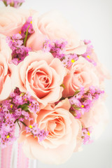 Bouquet of roses and pink statice with photo filter