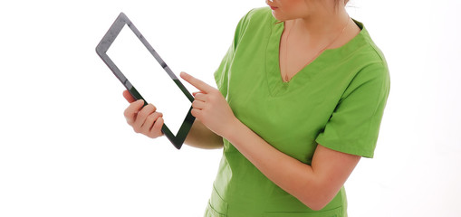 Female doctor in green medical suit holds tablet pc against white background