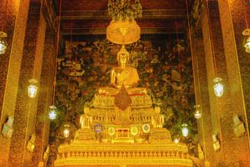 Buddha gold statue with thai art architecture in church Wat Pho (Temple of the Reclining Buddha). This is a Buddhist temple in Bangkok,Thailand. © iphotothailand