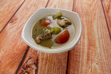 Chicken soup on wooden table. Top View.