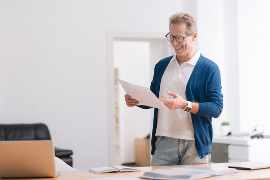Nice self employed man holding a document