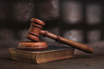 Law gavel on old brown leather book 