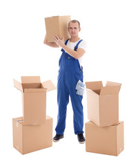 moving day concept - young man in blue workwear with cardboard b