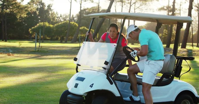 Two golf players getting into golf buggy at golf course 4k
