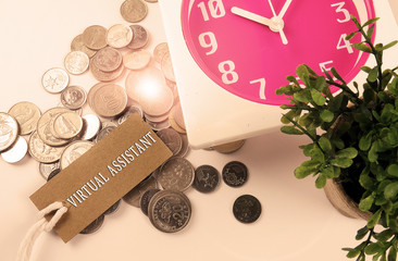 Red clock,coins,green plant and bookmark with time management conceptual text. Lens flare and shepia filter added. Retro and classic look.