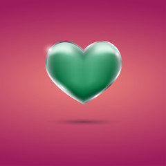 Glowing green heart with frame on pink background