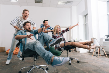 Joyful happy people sitting in the office chairs