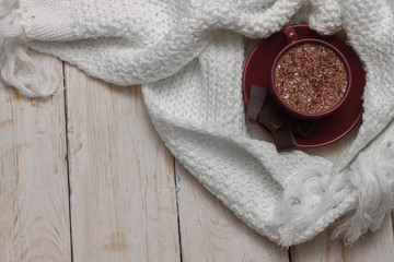 Milk chocolate in a cup on a saucer against a background of a sc
