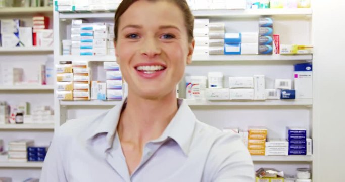 Portrait of pharmacist checking a medicine in pharmacy