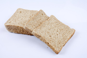 Loaf of wholemeal bread on white background