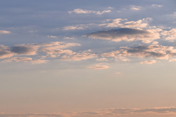 Sky with blue-gray clouds at orange sunset