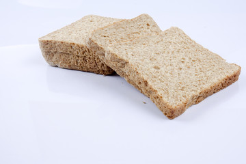 Loaf of wholemeal bread on white background