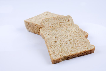 Loaf of wholemeal bread on white background