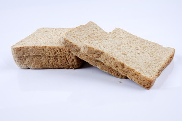 Loaf of wholemeal bread on white background