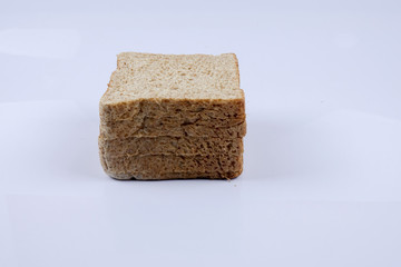 Loaf of wholemeal bread on white background