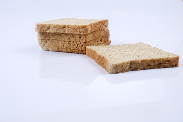Loaf of wholemeal bread on white background