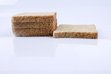 Loaf of wholemeal bread on white background