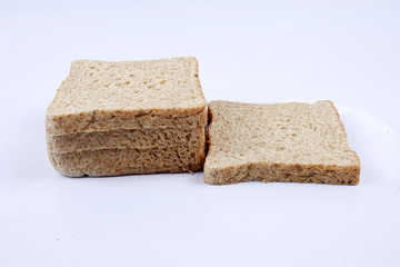 Loaf of wholemeal bread on white background