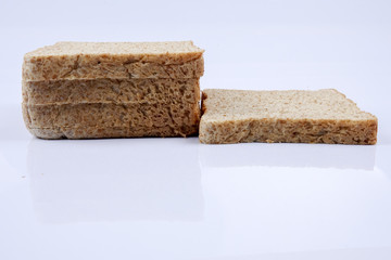 Loaf of wholemeal bread on white background