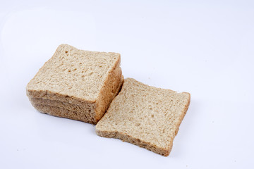Loaf of wholemeal bread on white background