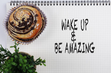 Inspirational word concept with crossaint ,green plant and note book.