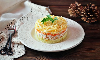 Salad of boiled potatoes, carrots, eggs, hard cheese, smoked chicken breast and white onion with mayonnaise. Russian traditional festive salad.