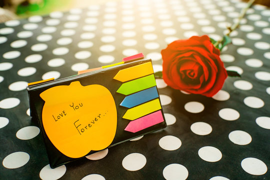 Post-it with message love you forever. Collection of different colored sheets of note papers and Red Roses flower for Valentine Day . Customize colors Vintage retro and old film Tone