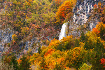 Periodic incredible waterfall in the autumn mountains