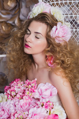 Obraz na płótnie Canvas Fashion Beauty Model Girl with Flowers Hair. Bride. Perfect Creative Make up and Hair Style. Hairstyle. Bouquet of Beautiful Flowers.