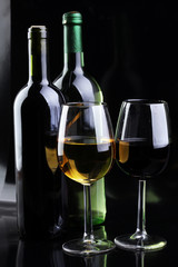 Wine glass and Bottle on black background. Red and white wine