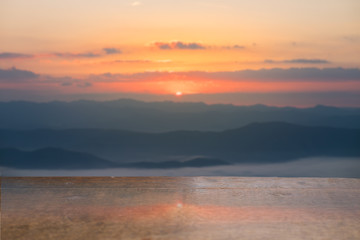 Selective foucus on Empty wooden table with the sunrise mountain view background. For display or montage your products.