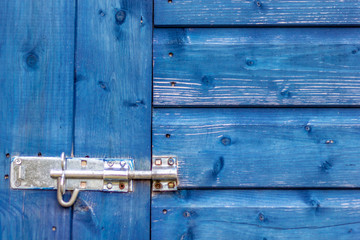Metal bracket or wooden door lock on wooden background