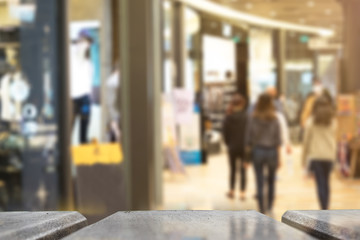 Selective foucus on Empty wooden table with the shopping mall have laday shopping background. For display or montage your products.