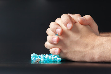 Male hand holding beads