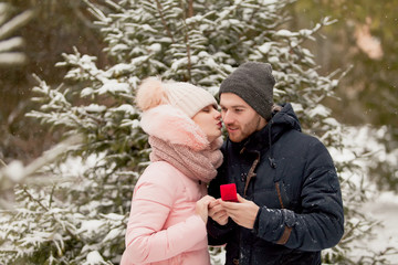 Young couple man and woman in winter Park