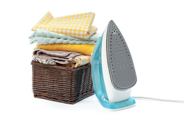 Electric iron and pile of clothes.