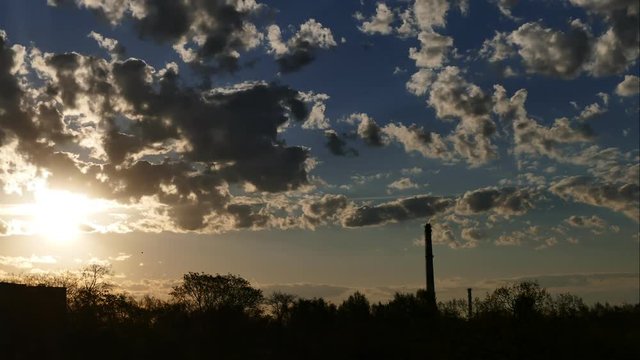 Sunrise Time Lapse Sky and moving clouds Power Plant pipe with smoke Latvia
