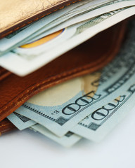 Brown leather wallet with USA dollars money
