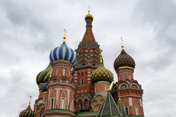 Fototapeta na wymiar Bottom view of St. Basil's Cathedral. Multicolored domes top this 16th-century now contains a museum of the church.