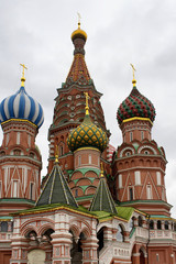 Fototapeta na wymiar Bottom view of St. Basil's Cathedral. Multicolored domes top this 16th-century now contains a museum of the church.