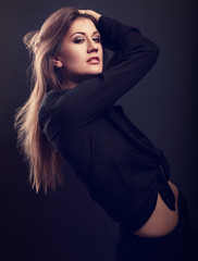 Sexy female slim model posing in black shirt with long hair styl