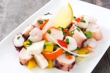 Traditional seafood ceviche from Peru on wooden background
