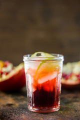 Pomegranate lemonade on black rustic metal table