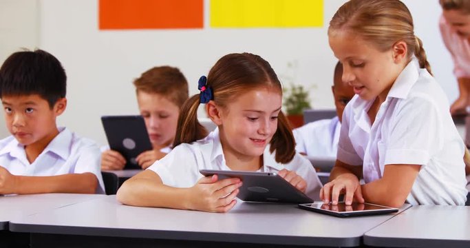 Students using digital tablet in classroom at school 4k