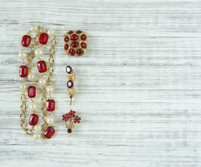 Woman's Jewelry. Vintage jewelry background. Beautiful bright rhinestone brooch and necklace on...